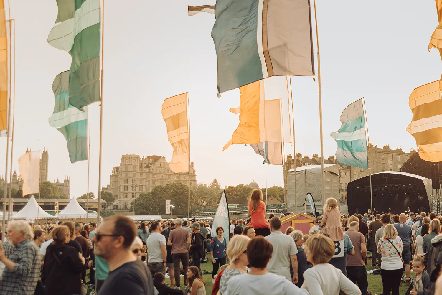 Crowds enjoying live music and performances at the Bath Festival in Bath, England.