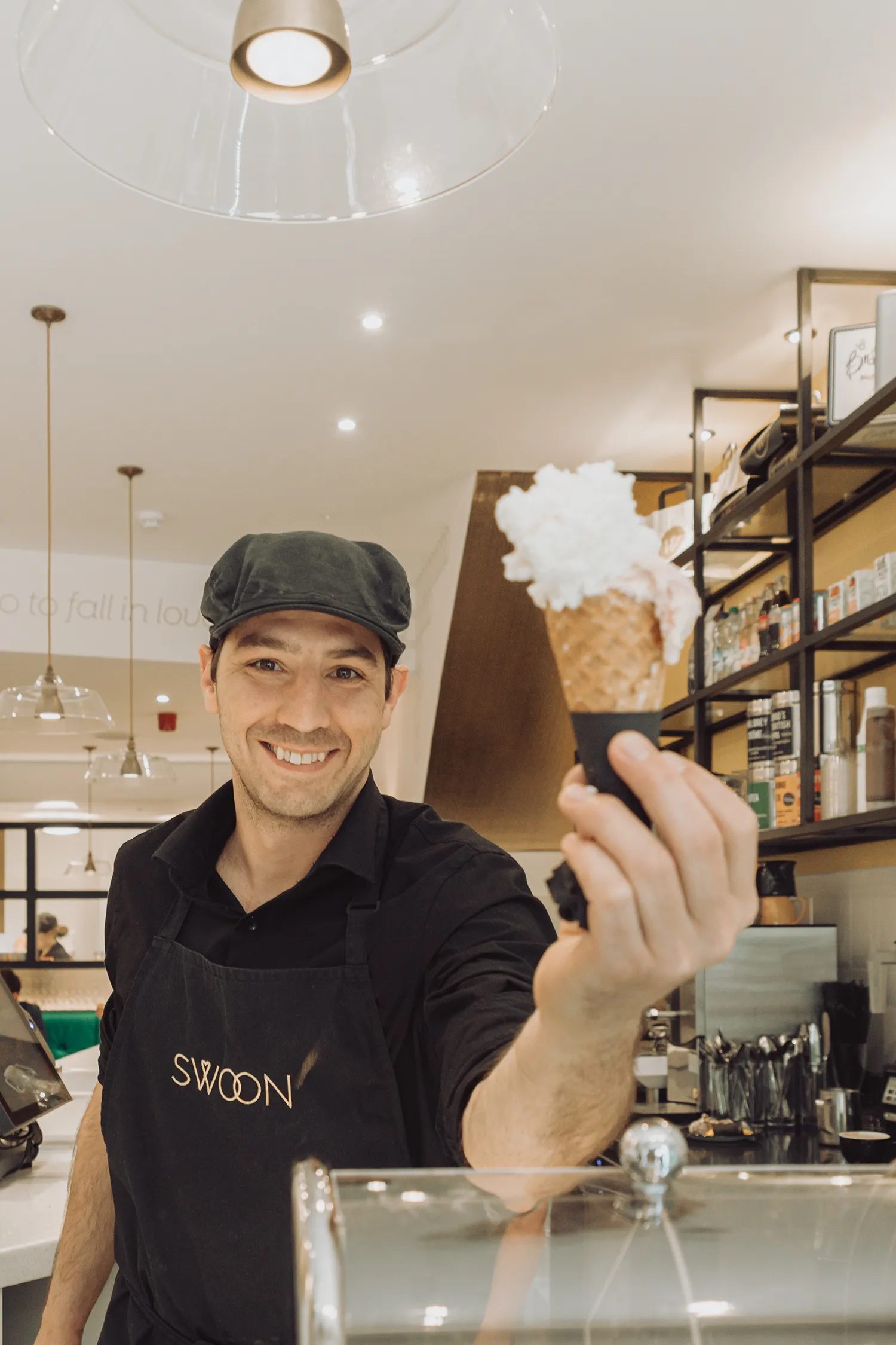 Gelato being handed over the counter at Swoon Gelato in Bath.