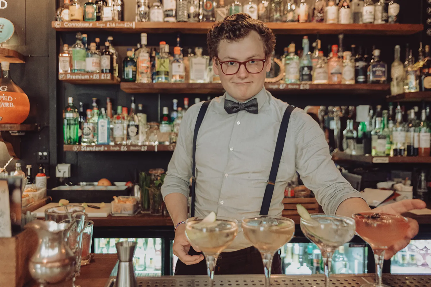 Bartender preparing cocktails at Bath Gin Bar in Bath, England.
