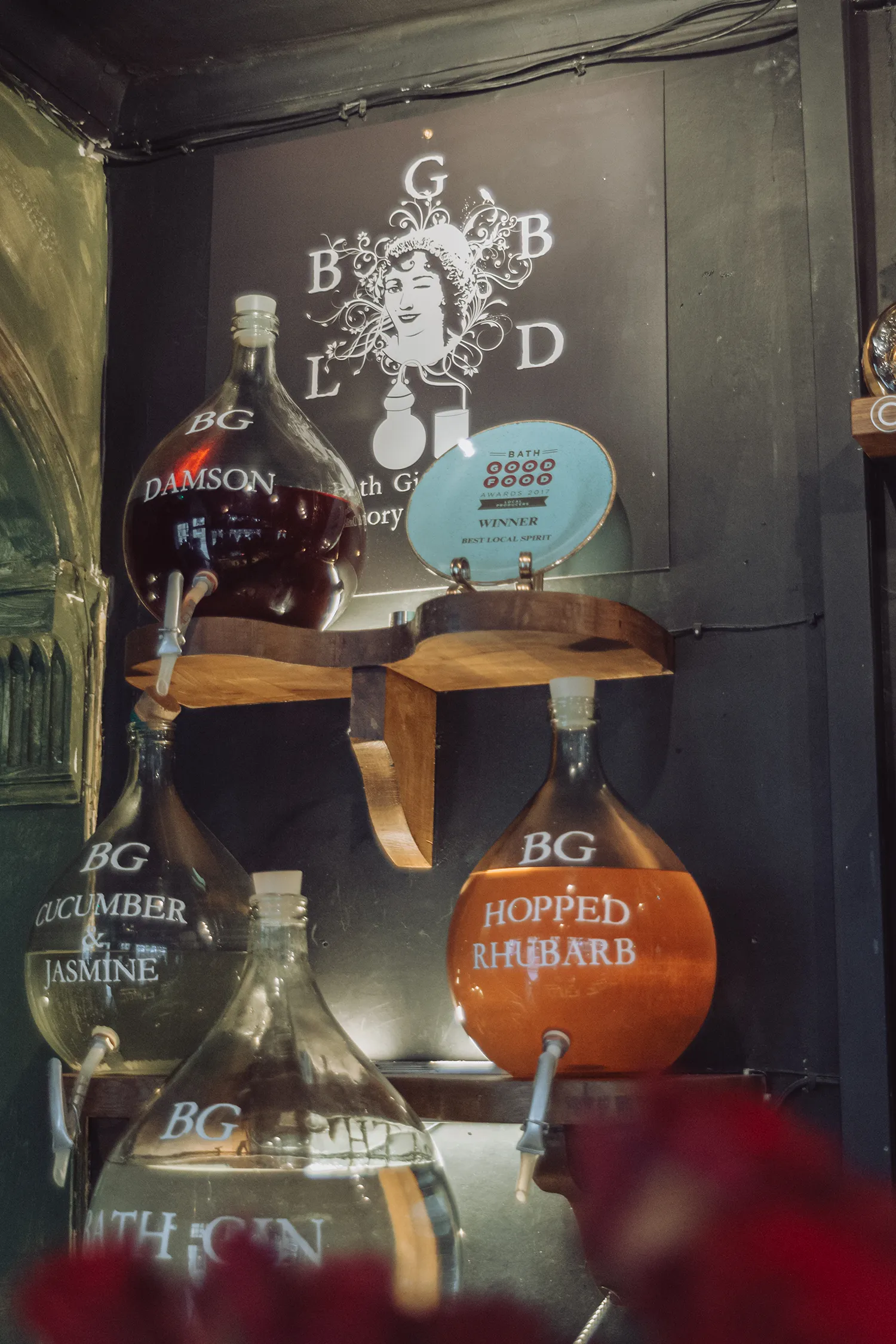 Infused gin bottles displayed at Bath Gin Bar in Bath, England.