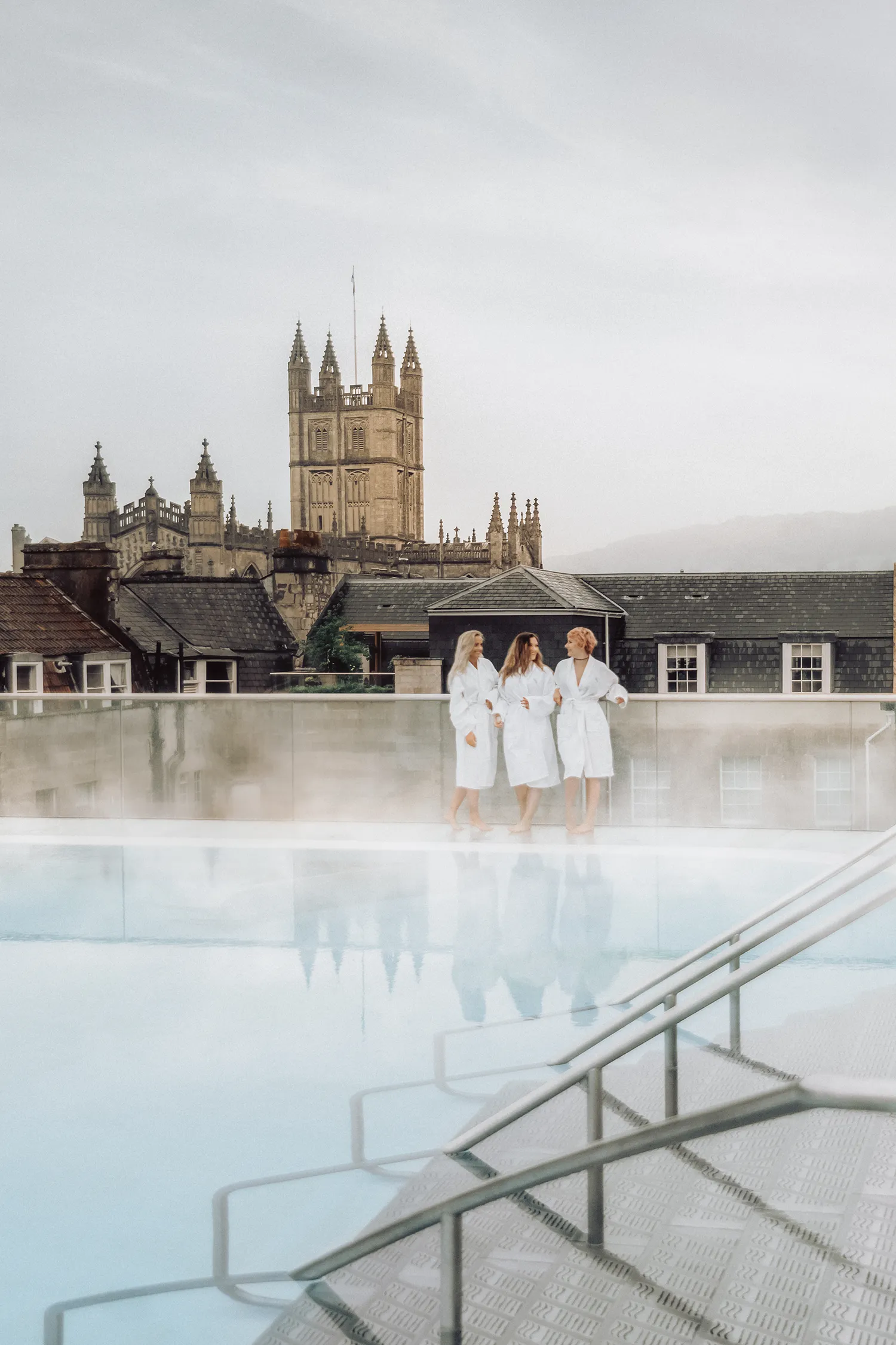 Nordic travel bloggers enjoying the rooftop thermal pool at Thermae Bath Spa, one of the best things to do in Bath.